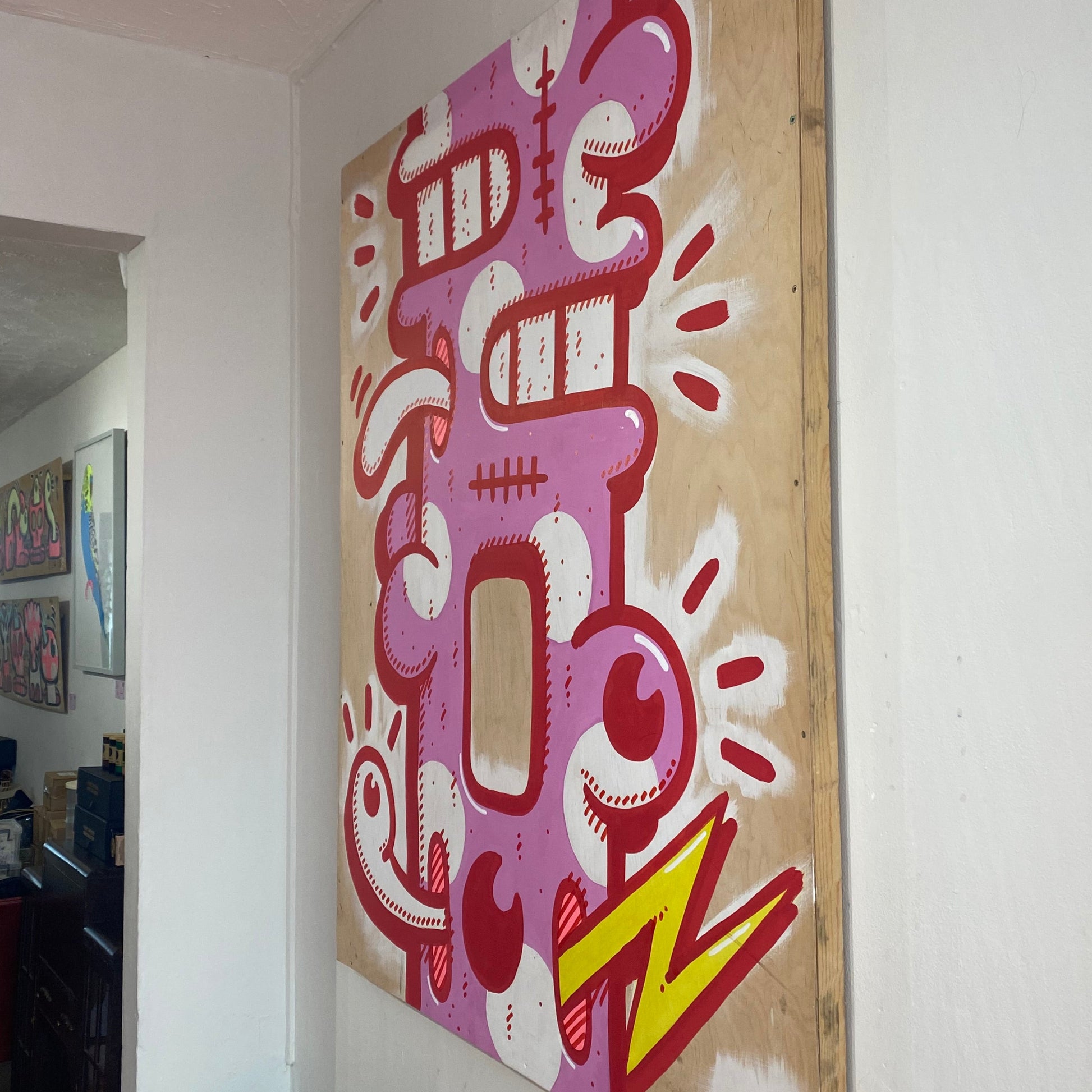 Abstract painting with pink, red and yellow on wood