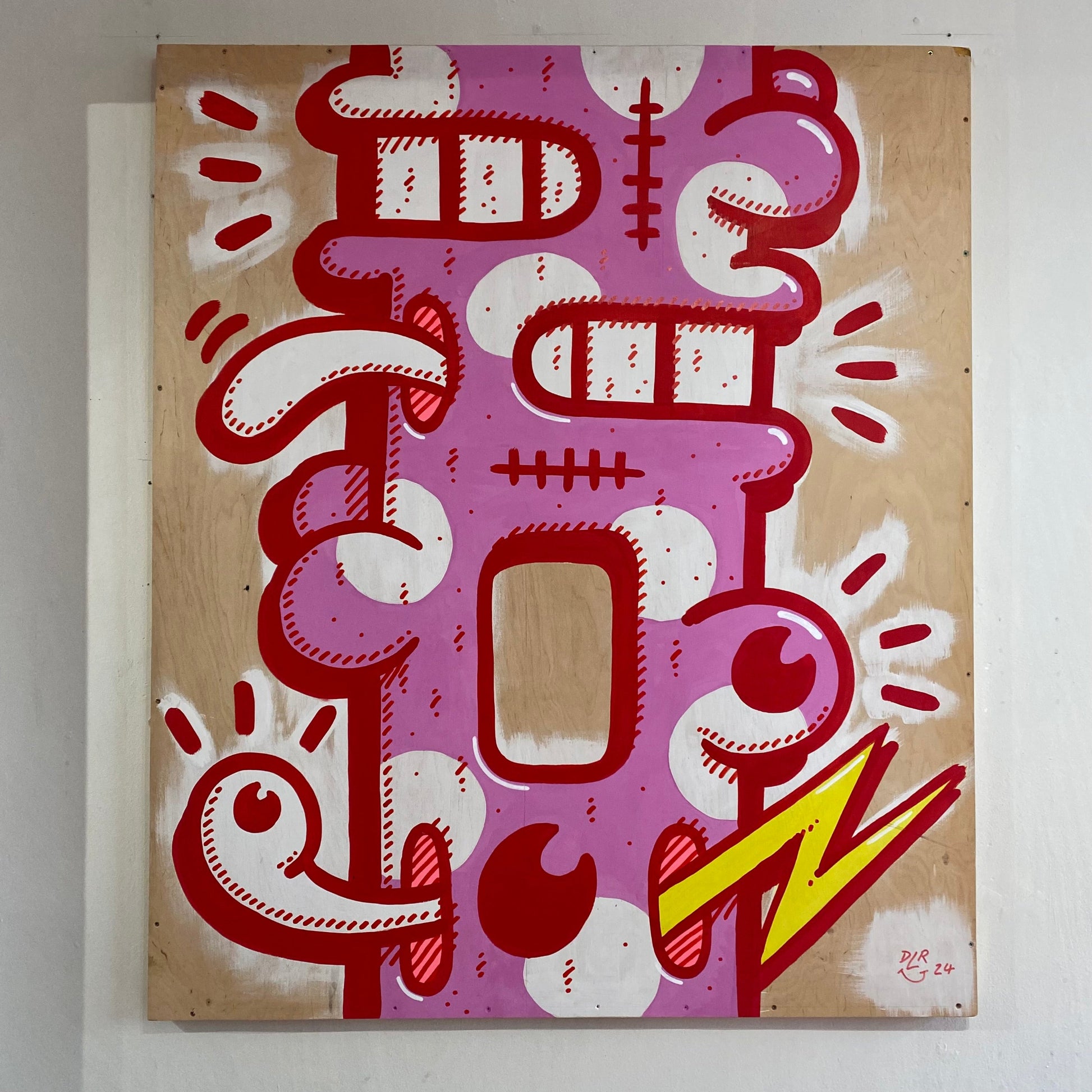 Abstract artwork with red, white, pink, and yellow design on a wooden background