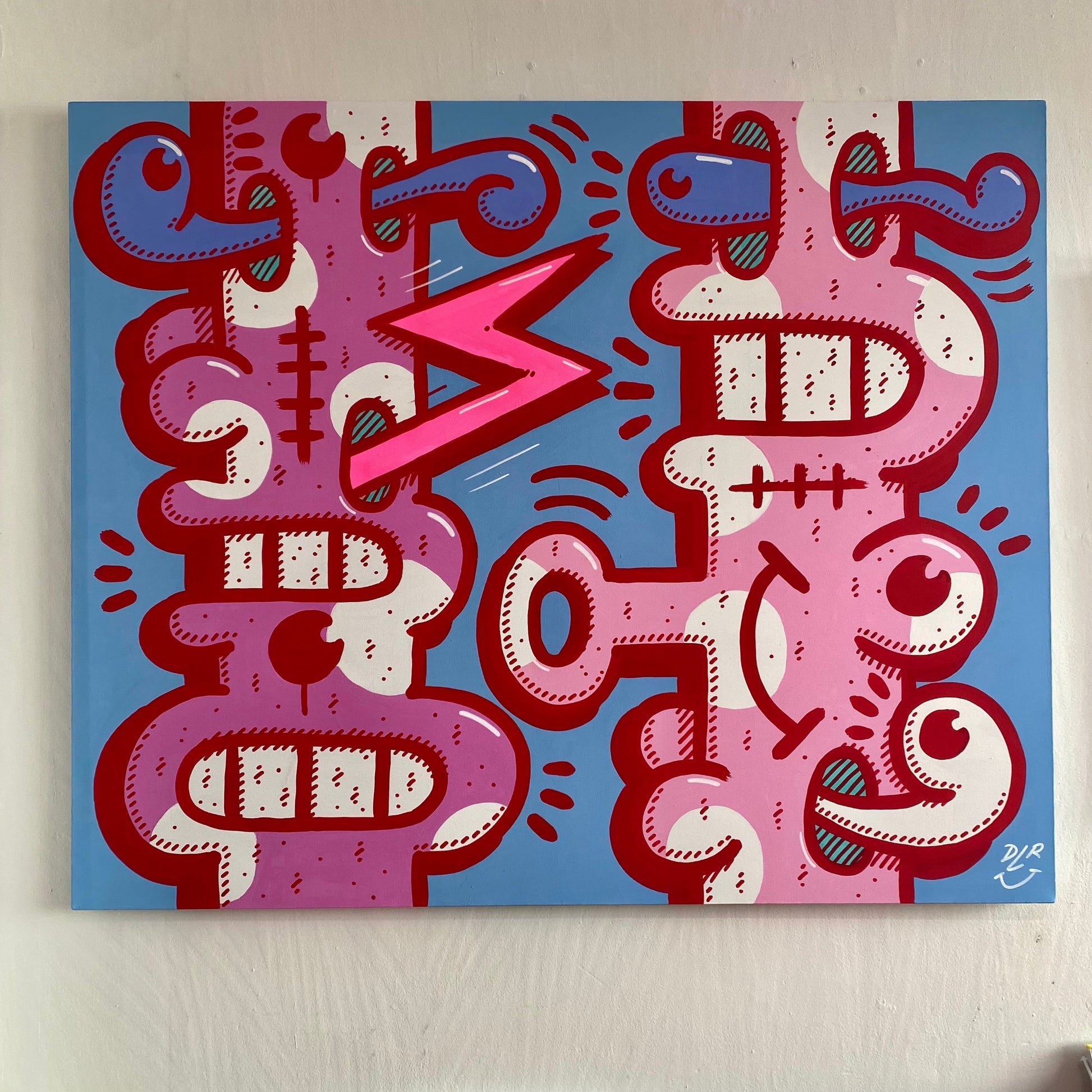 Abstract artwork with red, pink, and blue patterns on a light blue background