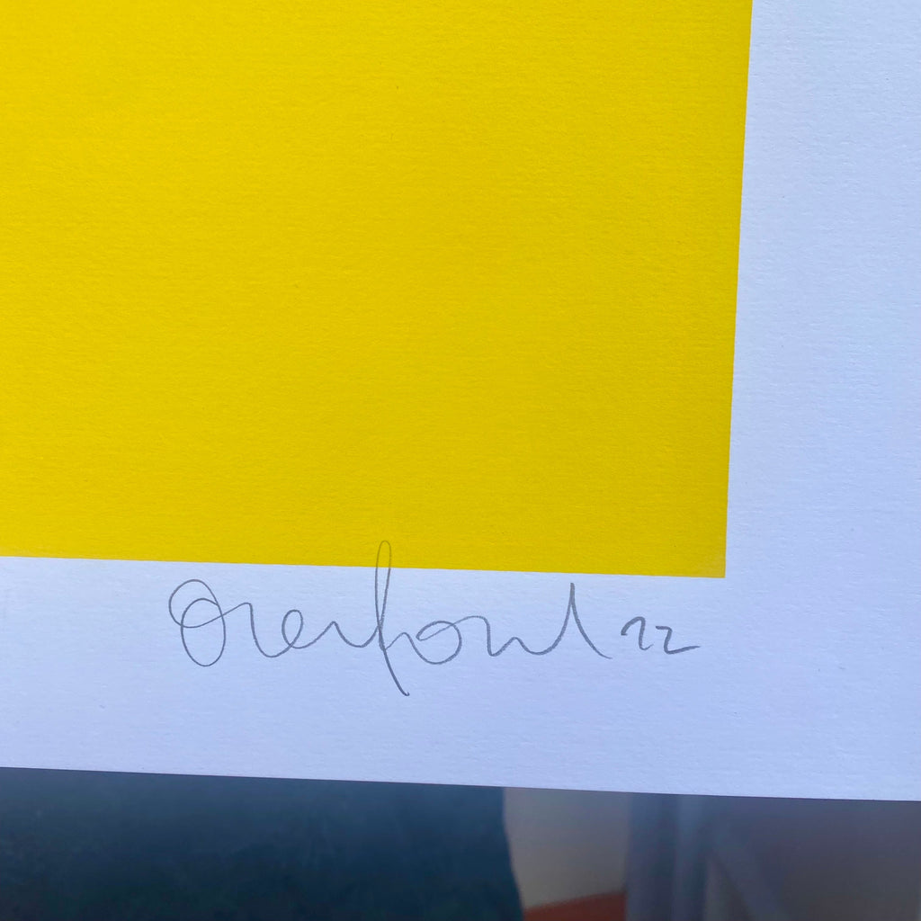 Yellow paper with a signature on a white background